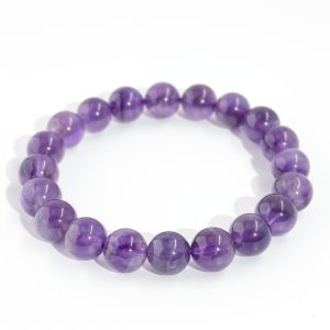 Natural amethyst bracelet with round translucent violet beads on elastic cord